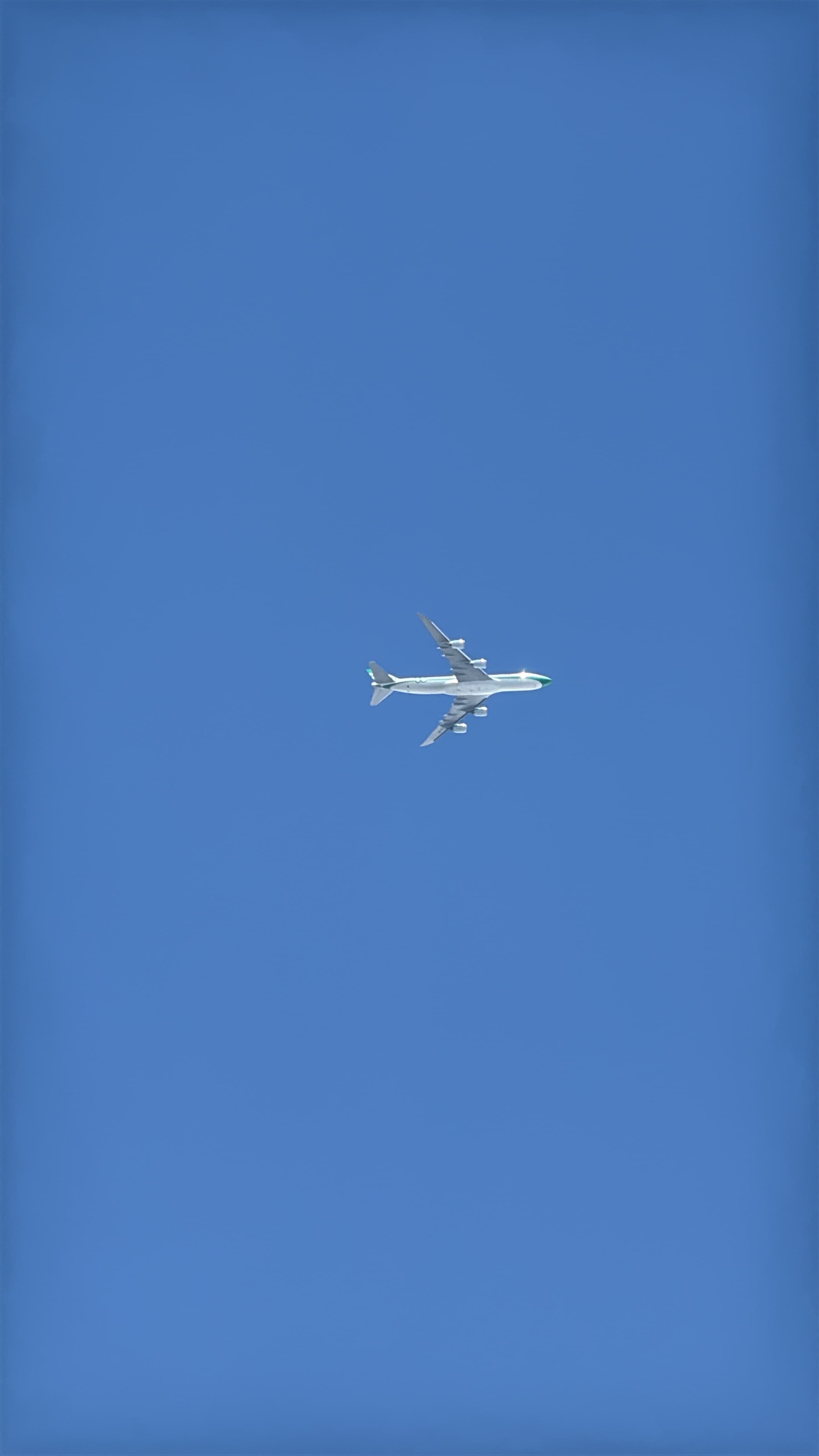 Cathay Pacific Boeing 747-8 B-LJE viewed from below against blue sky